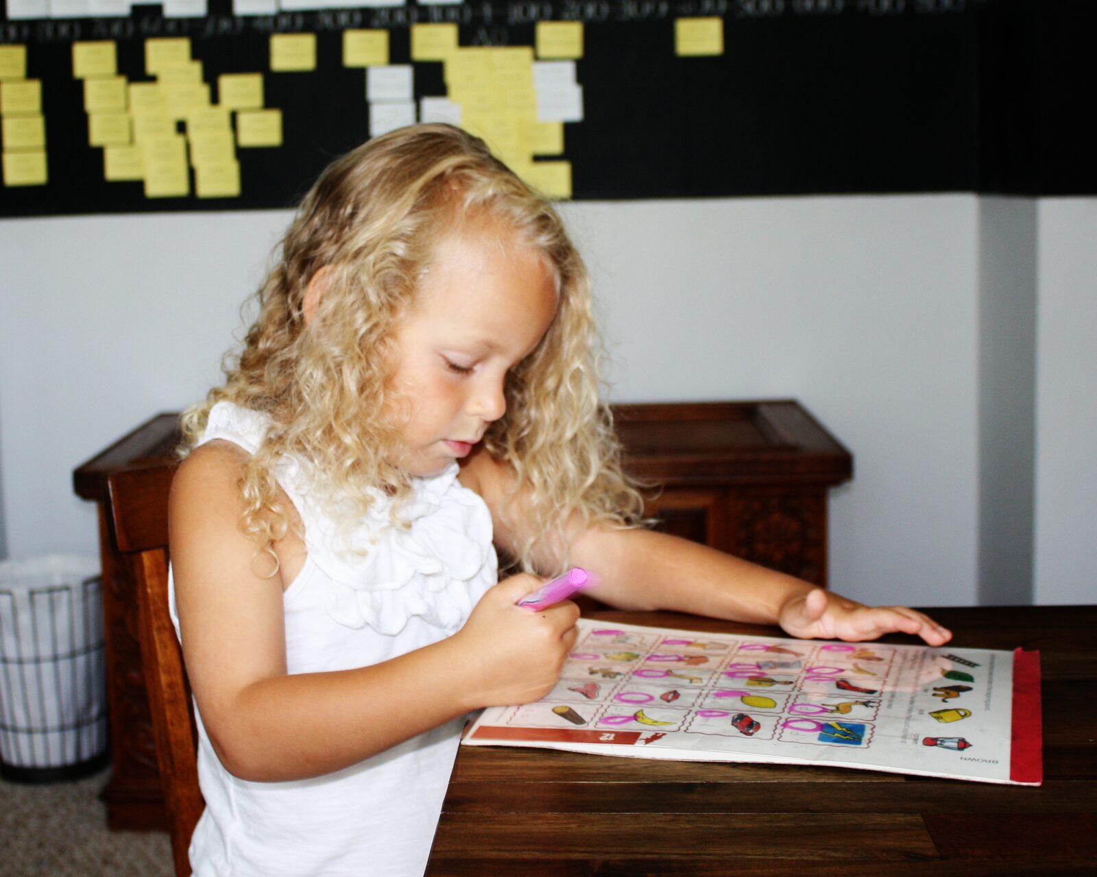 A child engaged in reading aloud with the family